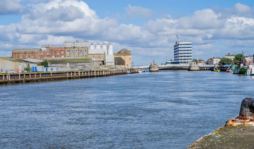 Bridge over river with buildings in background