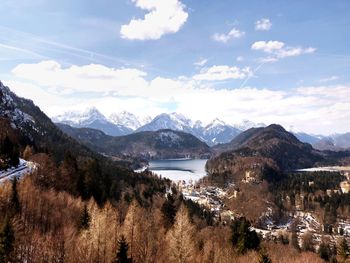 Scenic view of lake by mountains against sky