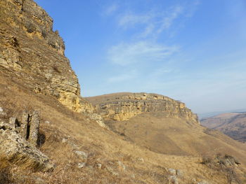 Low angle view of rock formations against sky