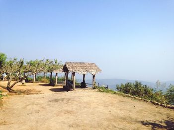 Gazebo on beach against clear sky