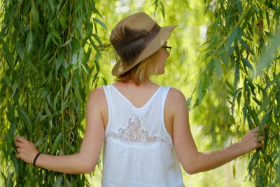 Rear view of woman standing on field