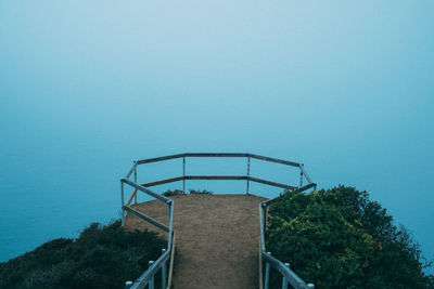 Low angle view of staircase against blue sky