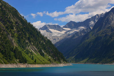 Scenic view of lake and mountains against sky