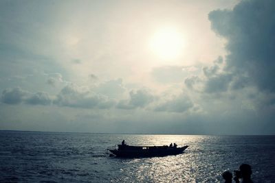 Silhouette boat sailing on sea against sky during sunset