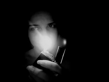 Close-up of woman hand over black background