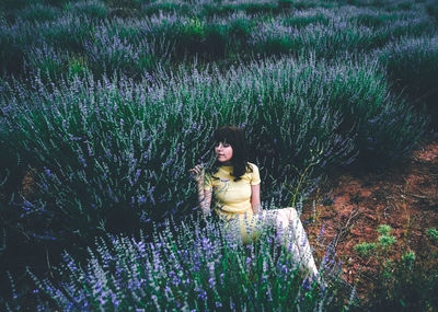 Portrait of woman on field during rainy season