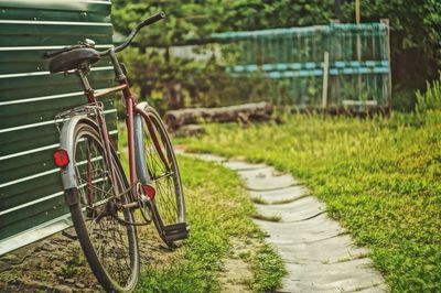 Bicycle leaning on field