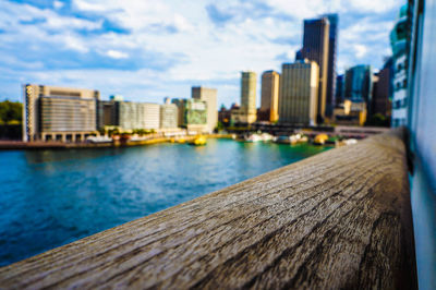 Sea by cityscape against sky