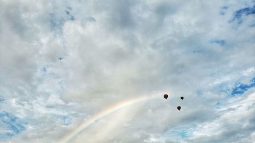 Low angle view of balloons flying against sky