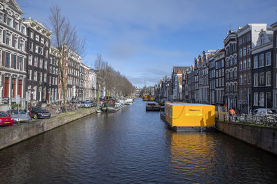 Canal amidst buildings in city