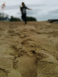 Close-up of sand on beach against sky