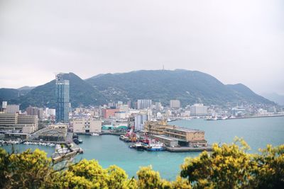 High angle view of bay and buildings against sky