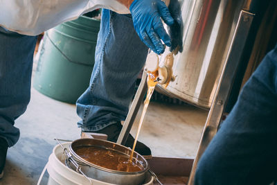 Low section of worker filling container