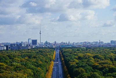 View of buildings in city against cloudy sky