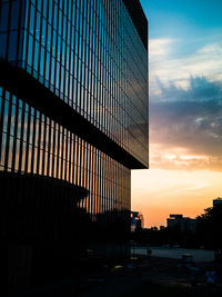 Low angle view of silhouette buildings against sky during sunset