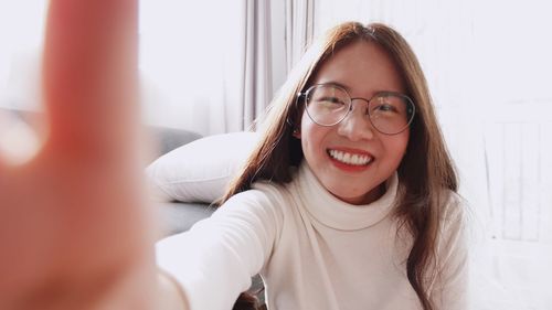 Portrait of smiling young woman at home