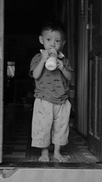 Portrait of cute baby boy standing at home