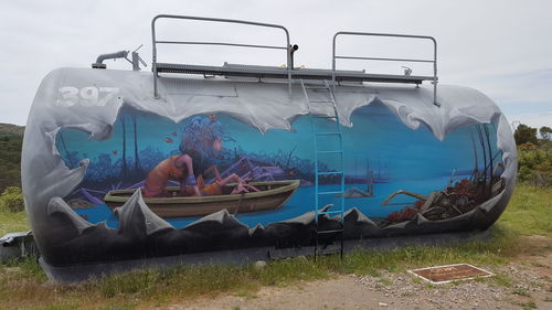 Panoramic view of fishing boats on land against sky