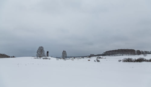 Snow covered land against sky