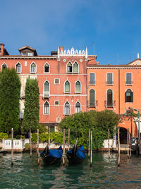 Boats in canal against buildings in city