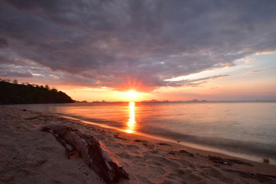 Scenic view of beach against sky during sunset