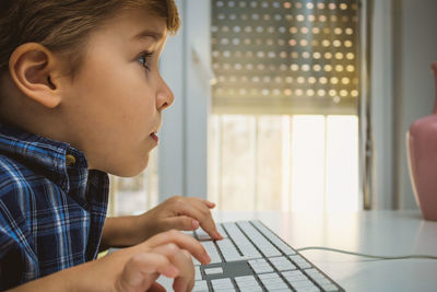 Boy using computer at desk