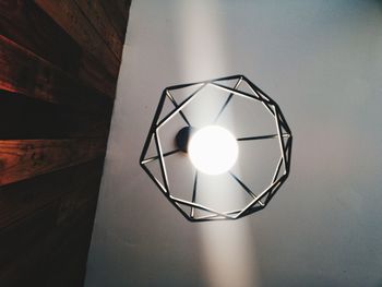 Low angle view of light bulb hanging on ceiling