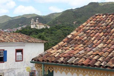 Houses on mountain against sky