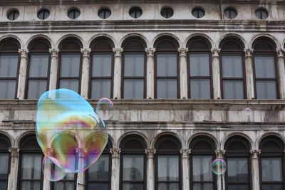 Soap bubbles with building in background