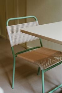 High angle view of empty chair on table at home