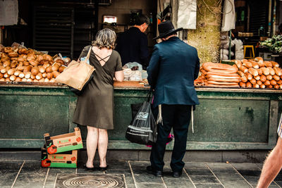 Rear view of people at market stall