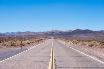 Empty country road against clear sky