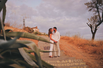 Full length of young couple romancing on steps