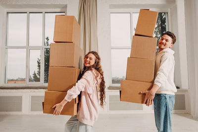 Portrait of smiling woman holding gift box