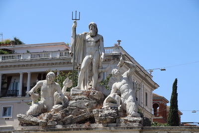 Low angle view of statue against clear blue sky