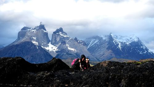 Tourists on snow covered landscape