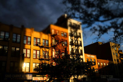 Low angle view of buildings lit up at night