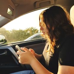 Side view of woman in car