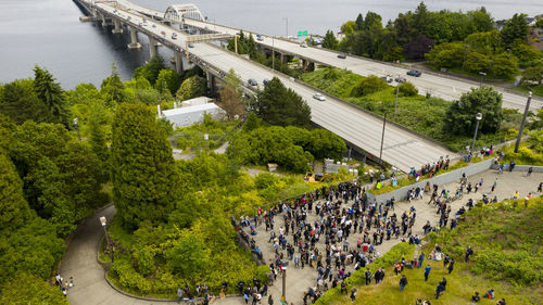 High angle view of people on road by trees in city