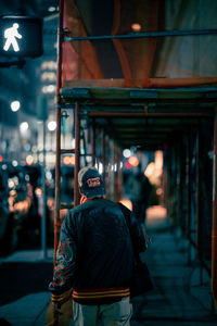 Rear view of man walking in city