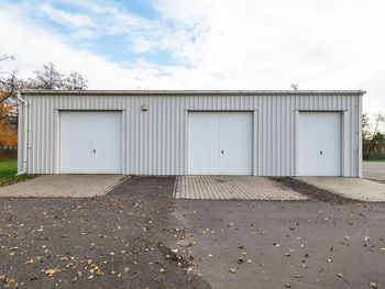 Garage building made of concrete with roller shutter doors. modern building for cars parking.