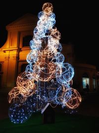 Low angle view of illuminated christmas tree at night