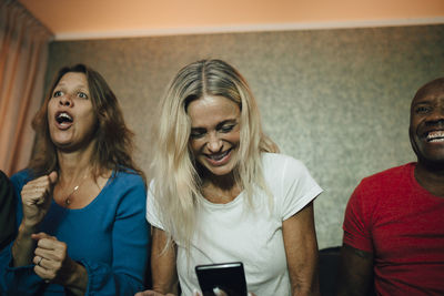 Portrait of smiling young woman using smart phone