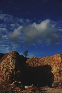 Low angle view of rock formation against sky