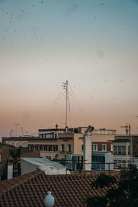 Houses against sky during sunset