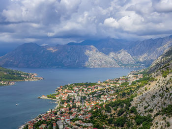 High angle view of townscape by sea against sky