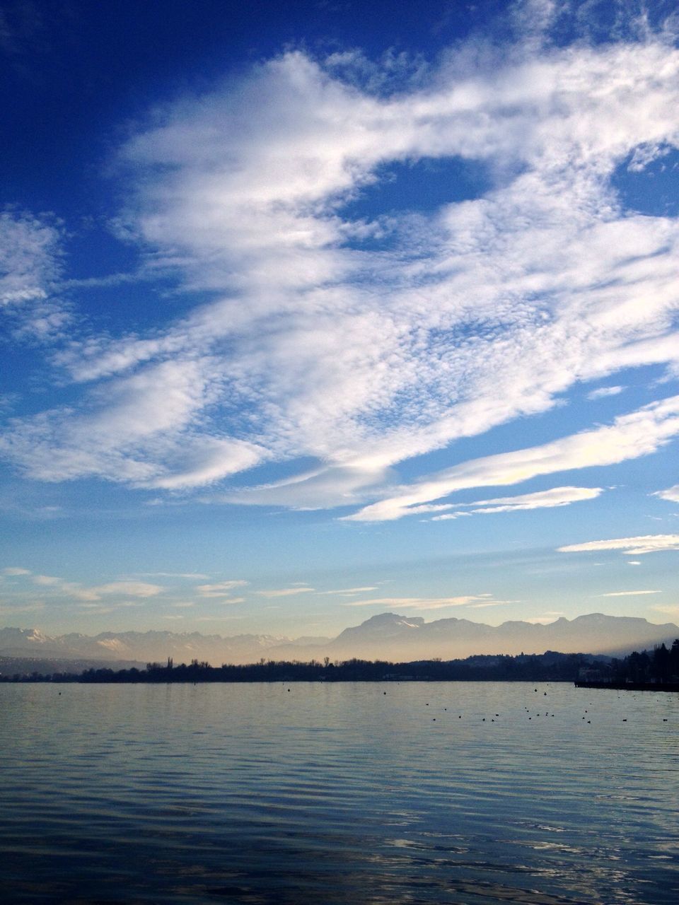 sky, tranquility, tranquil scene, water, scenics, beauty in nature, cloud - sky, cloud, nature, blue, reflection, idyllic, sea, lake, outdoors, cloudy, day, no people, non-urban scene, calm