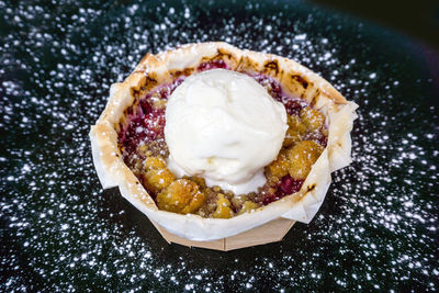 High angle view of apple pie surrounded with flour