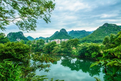 Scenic view of lake and mountains against sky