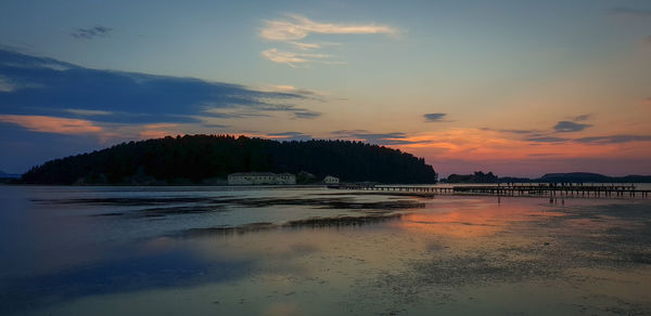 Scenic view of beach against sky during sunset